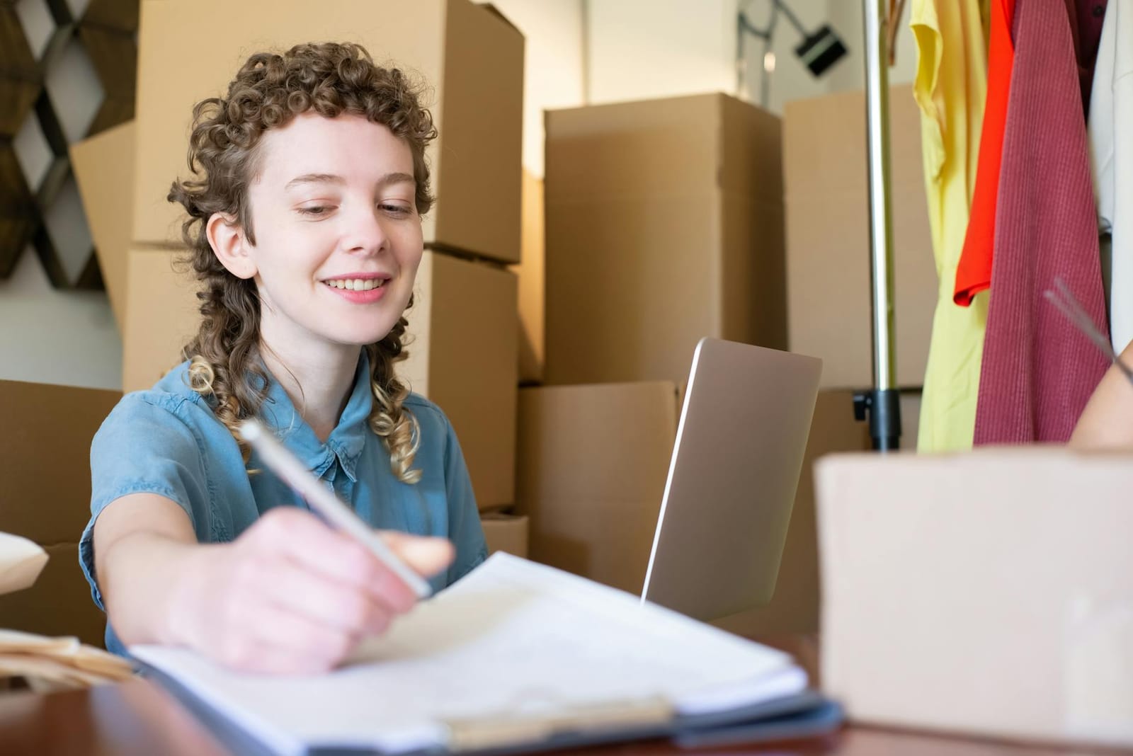 Online store owner reviewing product-research notes at a laptop